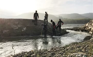 Fischer stehen beim Einstieg der Fischwanderhilfe an der Donau